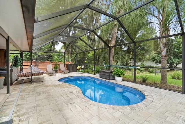 view of swimming pool with a lanai and a patio