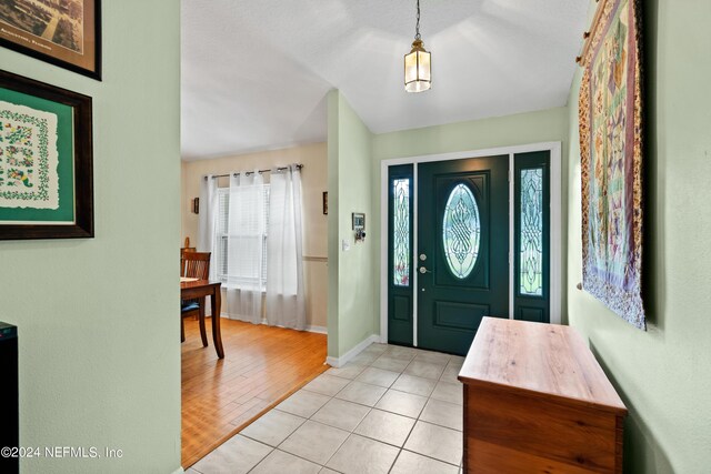 entryway featuring a textured ceiling and light hardwood / wood-style flooring