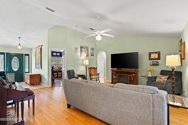 living room featuring light wood-type flooring, vaulted ceiling, and ceiling fan