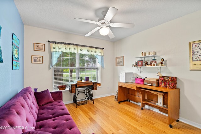 interior space featuring a textured ceiling, ceiling fan, and hardwood / wood-style flooring