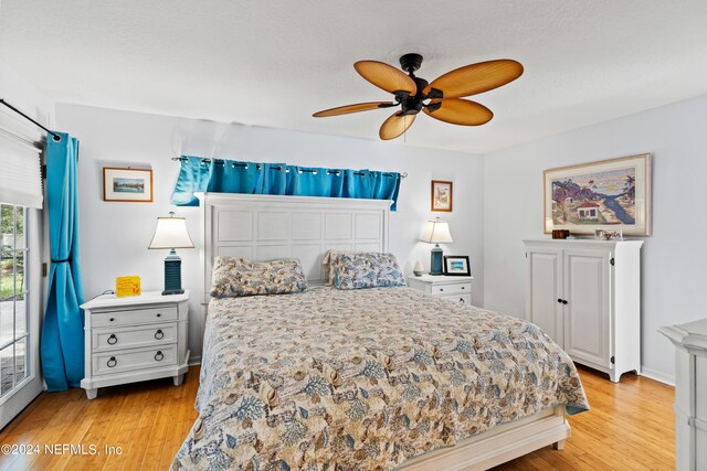 bedroom with light wood-type flooring and ceiling fan