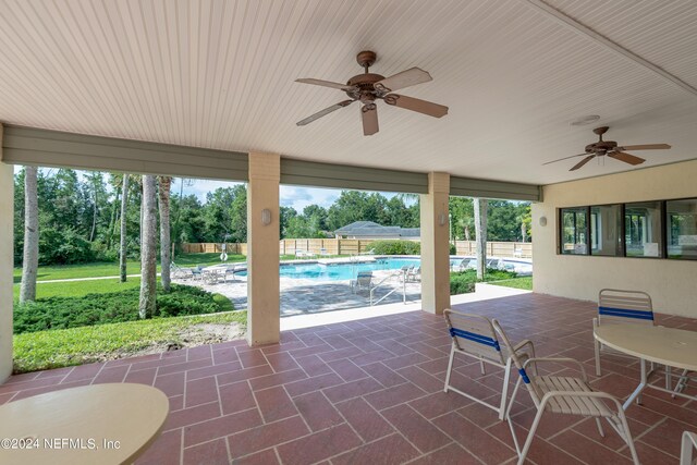 view of patio with a fenced in pool and ceiling fan