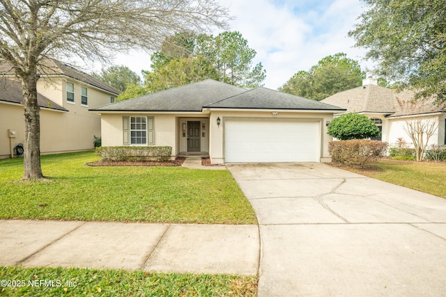 view of front of property with a front lawn and a garage