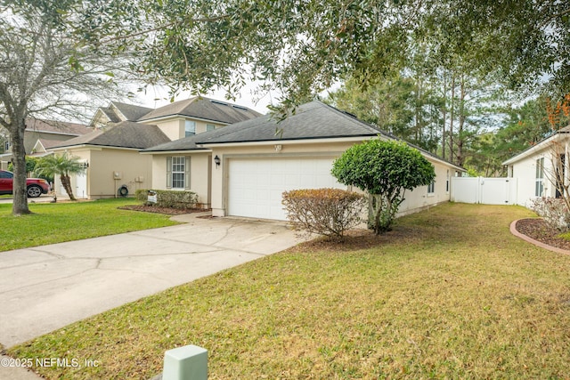 view of front of property featuring a garage and a front lawn