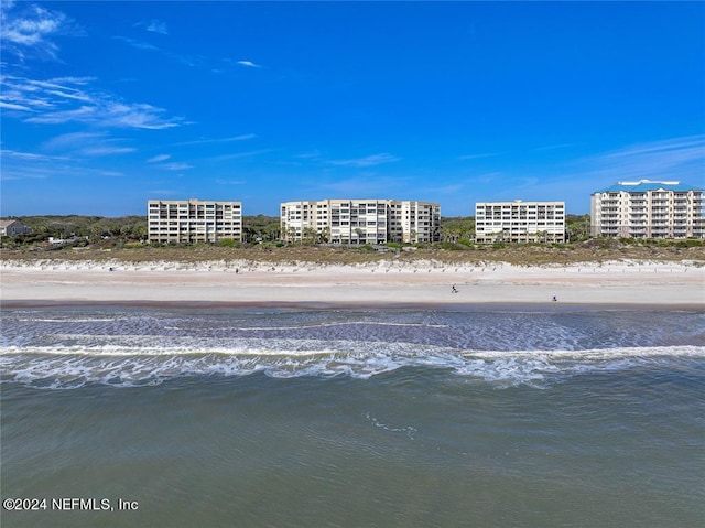 bird's eye view featuring a water view and a beach view