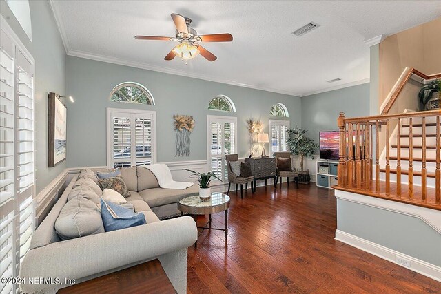 living room featuring a textured ceiling, ceiling fan, crown molding, and dark hardwood / wood-style flooring