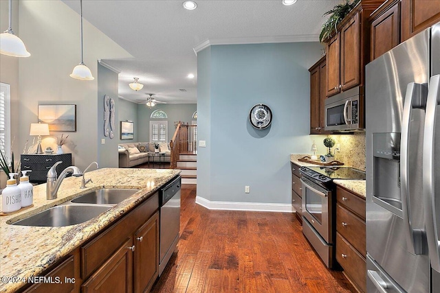 kitchen with sink, decorative light fixtures, appliances with stainless steel finishes, crown molding, and dark hardwood / wood-style flooring