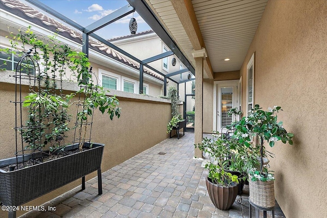 view of patio featuring a lanai