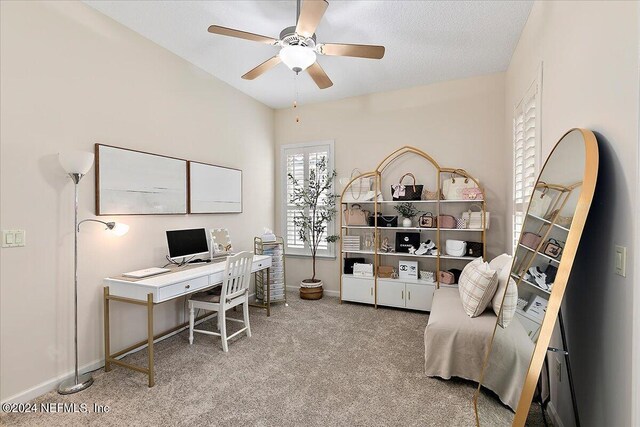 home office with carpet floors, a textured ceiling, and ceiling fan