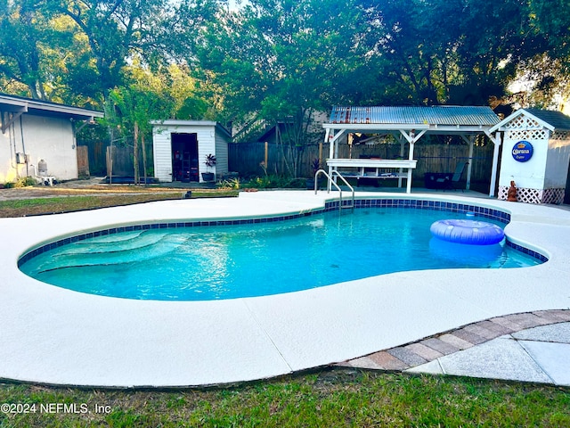 view of pool featuring a storage shed and a patio area