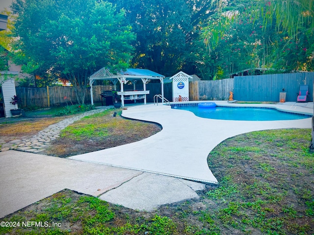 view of swimming pool featuring a patio and a gazebo