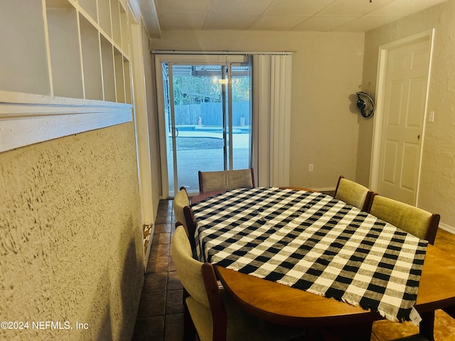 bedroom featuring access to exterior and dark tile patterned floors