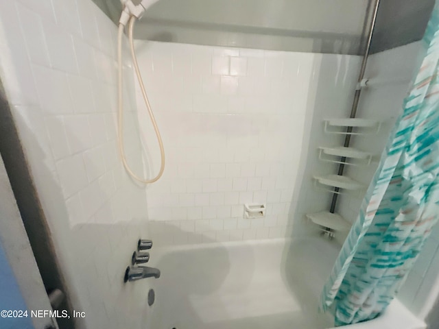 bathroom featuring shower / tub combo with curtain