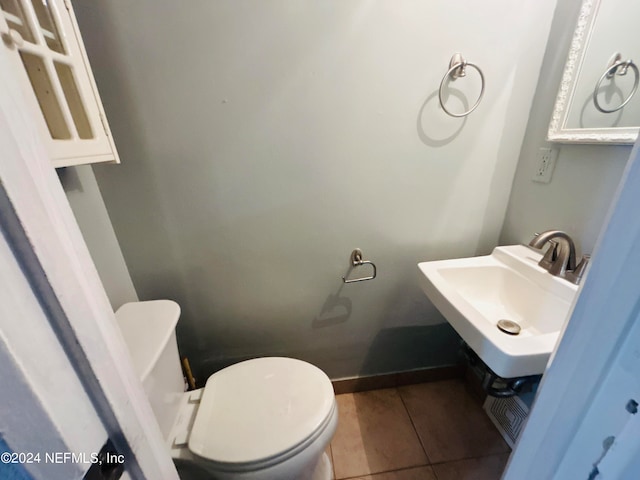 bathroom with sink, toilet, and tile patterned floors