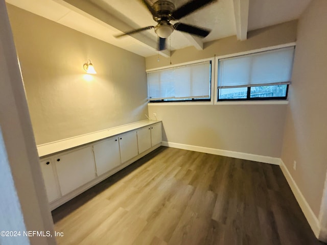 unfurnished room with light wood-type flooring, beamed ceiling, and ceiling fan