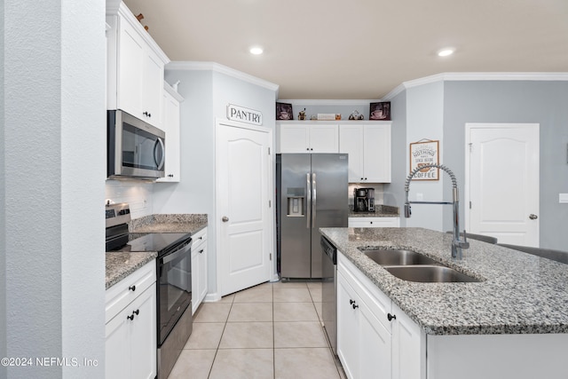 kitchen with an island with sink, stainless steel appliances, white cabinetry, and sink