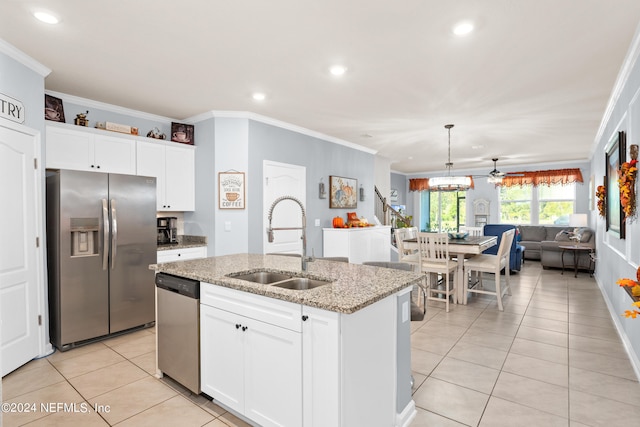 kitchen with white cabinets, an island with sink, appliances with stainless steel finishes, and sink