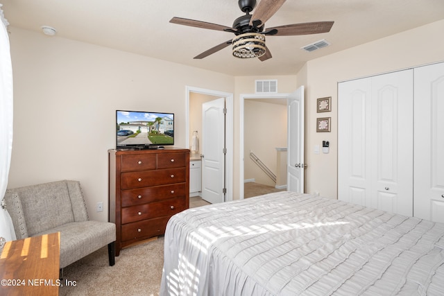 carpeted bedroom featuring a closet and ceiling fan