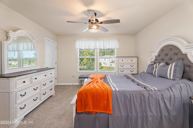 carpeted bedroom with ceiling fan and multiple windows