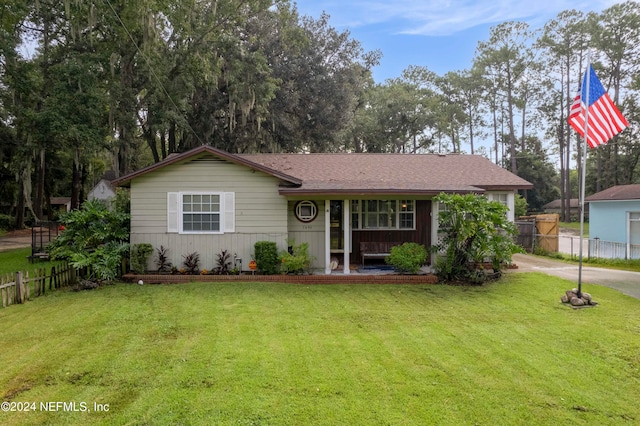 single story home with a porch and a front lawn