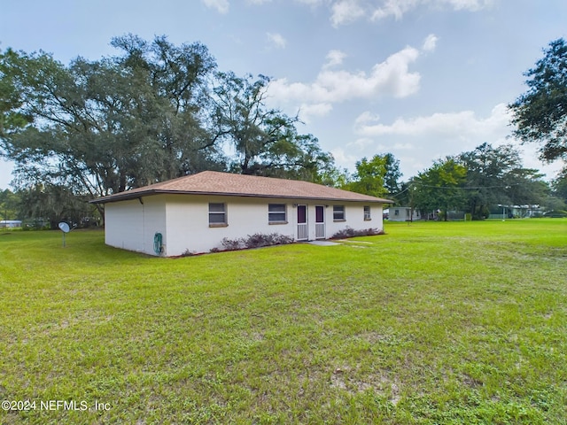 rear view of house with a lawn