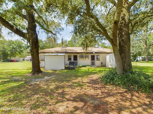 rear view of house with a yard