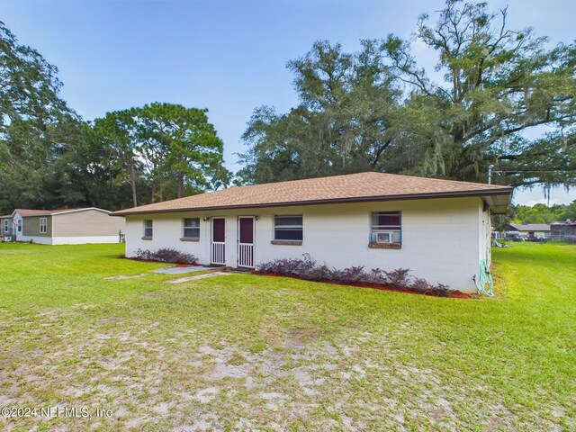back of house with a lawn