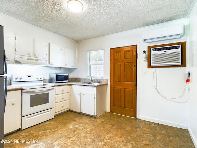 kitchen with electric stove, stainless steel microwave, under cabinet range hood, a wall unit AC, and a textured ceiling