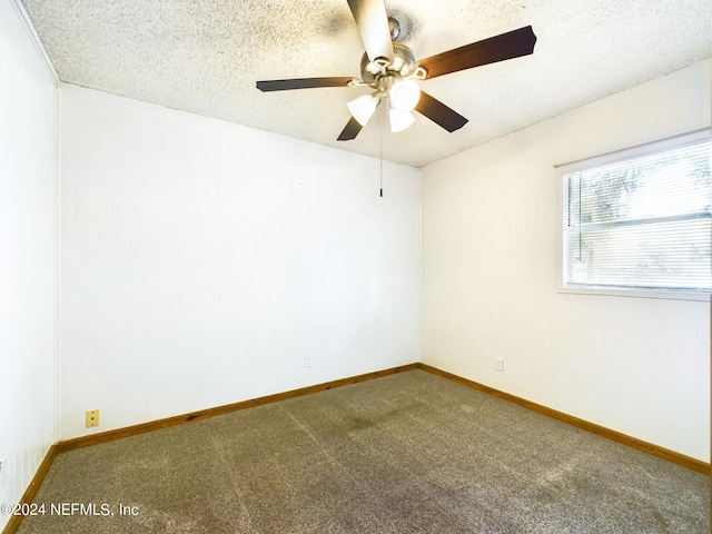 unfurnished room with carpet, a ceiling fan, baseboards, and a textured ceiling