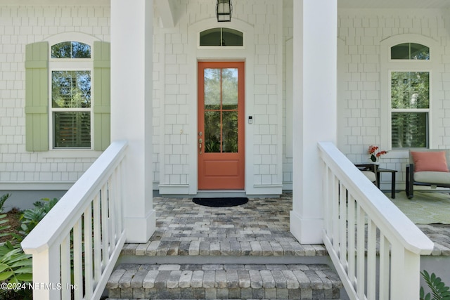 view of exterior entry featuring a porch