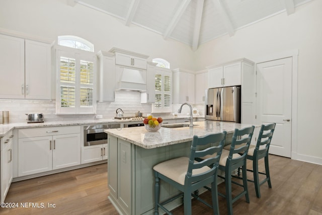 1505 Lakeside Ct, Fernandina Beach, FL 32034 - kitchen featuring a sink, white cabinetry, decorative backsplash, and appliances with stainless steel finishes