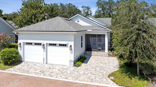 1505 Lakeside Ct, Fernandina Beach, FL 32034 - ranch-style house with driveway, a shingled roof, a garage, and a sunroom