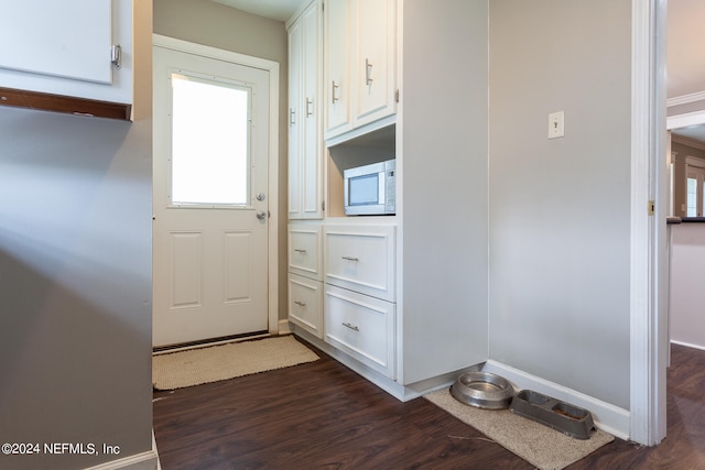 kitchen with dark hardwood / wood-style flooring and white cabinetry