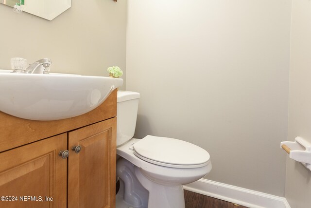 bathroom featuring hardwood / wood-style floors, vanity, and toilet