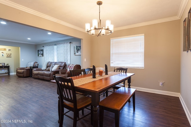 dining area with a chandelier, ornamental molding, and dark wood-type flooring