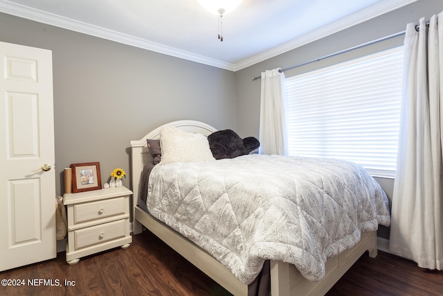 bedroom with dark hardwood / wood-style floors and ornamental molding