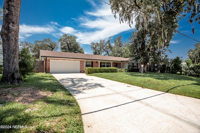 single story home featuring a front yard and a garage