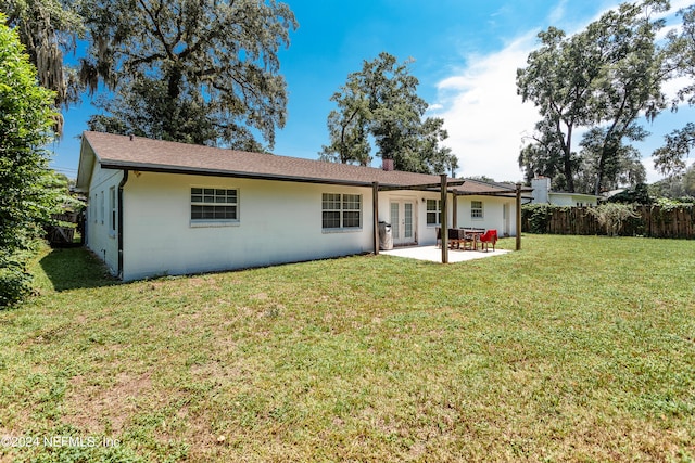 back of property featuring a yard and a patio