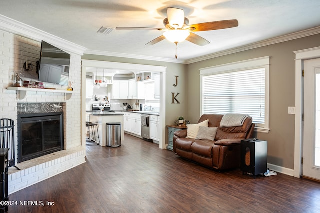 living room with sink, ceiling fan, ornamental molding, a fireplace, and dark hardwood / wood-style flooring