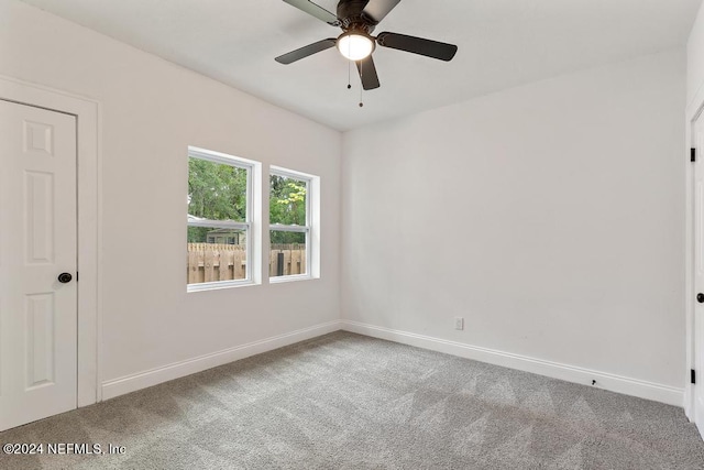 empty room with ceiling fan and carpet floors