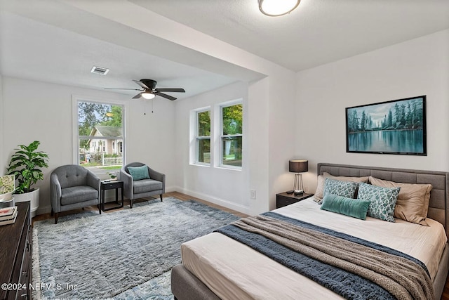 bedroom with ceiling fan and wood-type flooring