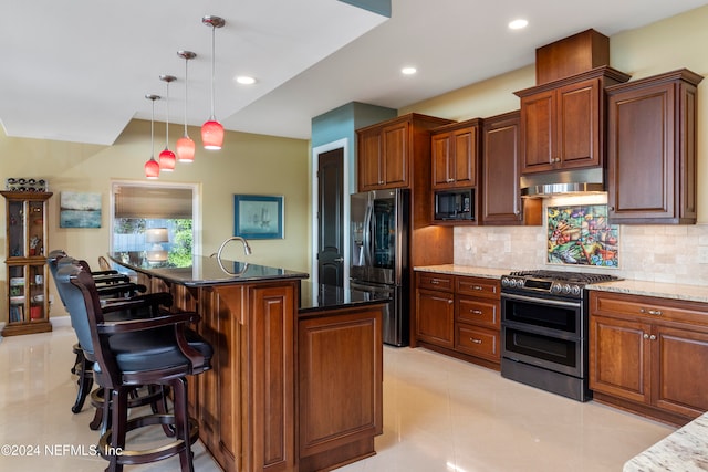 kitchen with backsplash, a center island, hanging light fixtures, stainless steel appliances, and dark stone counters