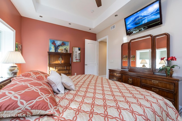 bedroom featuring a tray ceiling and ceiling fan