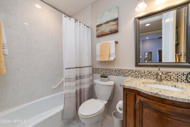 full bathroom featuring tile walls, vanity, shower / bath combination with curtain, and toilet