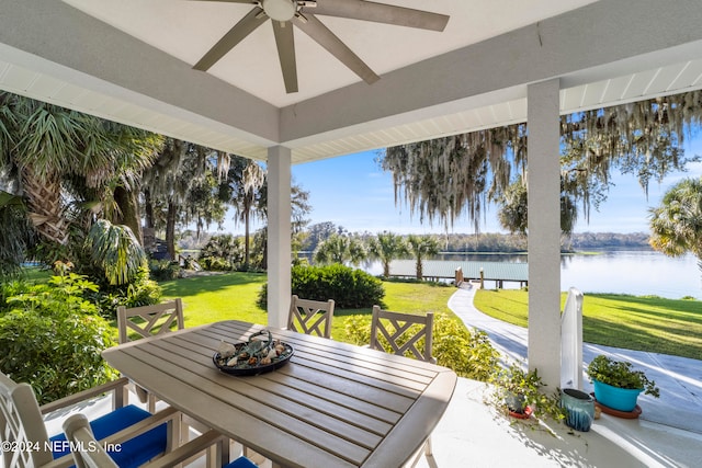 view of patio / terrace featuring a water view and ceiling fan