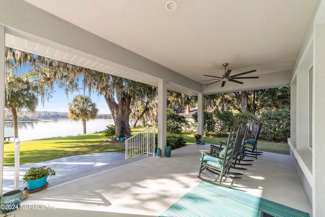 view of patio / terrace featuring a water view and ceiling fan