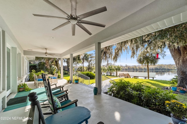 view of patio / terrace featuring a water view and ceiling fan