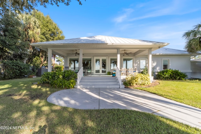 view of front of house with a front yard, a porch, and ceiling fan