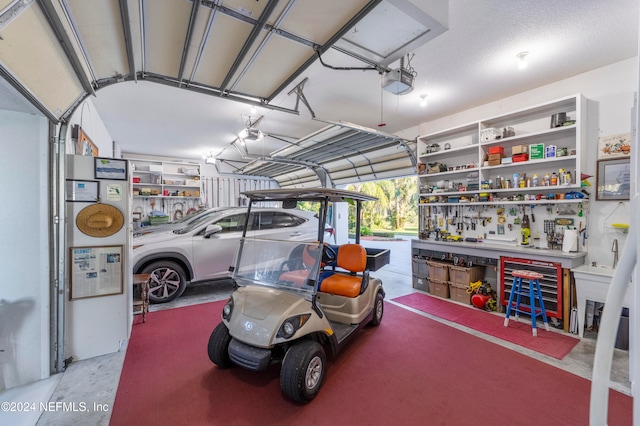 garage with a garage door opener and a workshop area