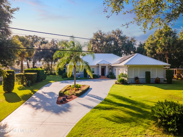 ranch-style house with a front lawn